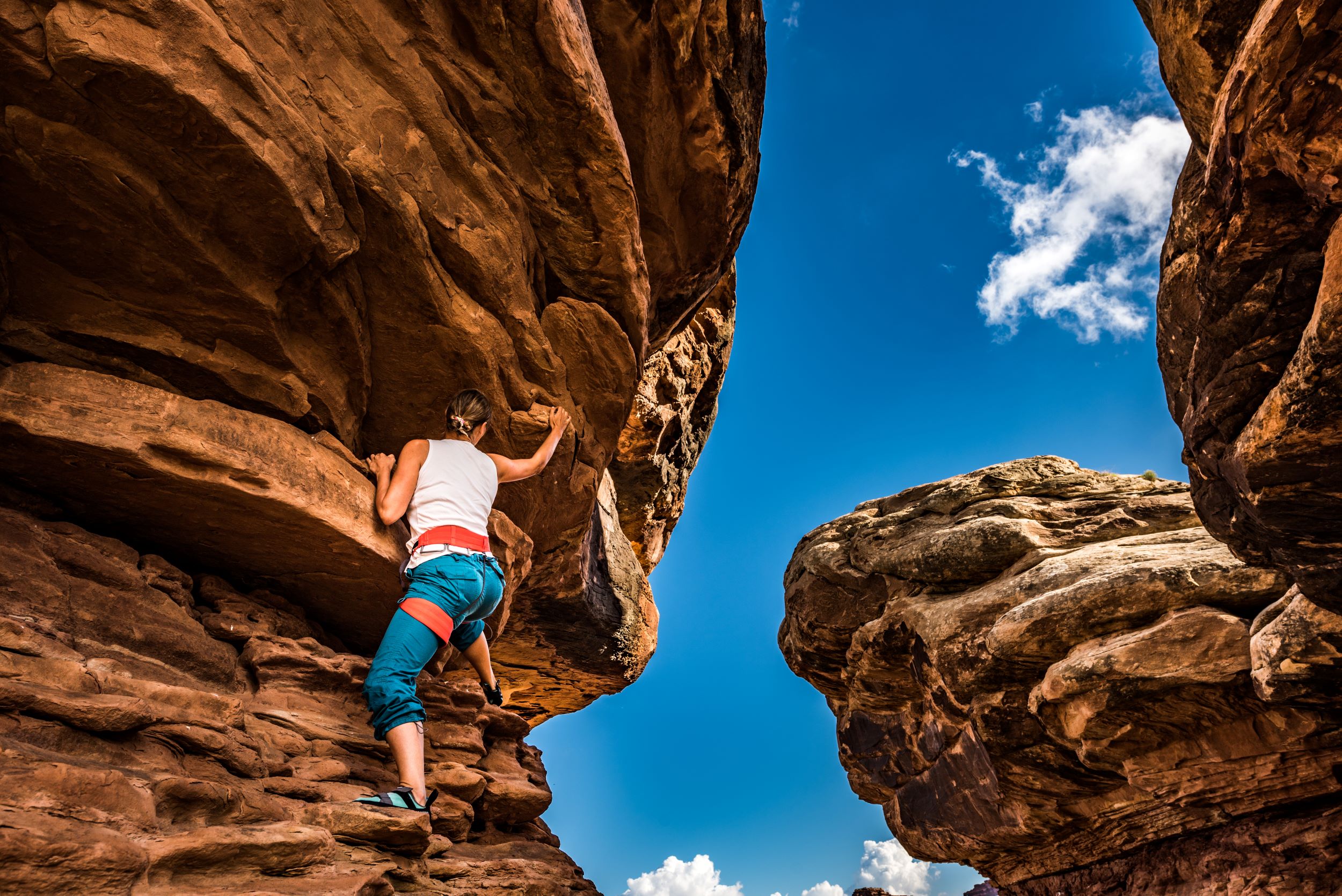 A climber on one of Utah's many red rock cliffs.