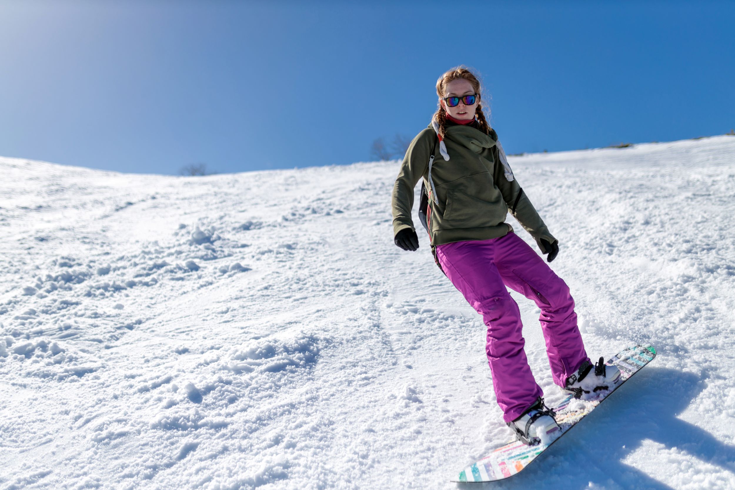 A woman snowboarding in Utah.
