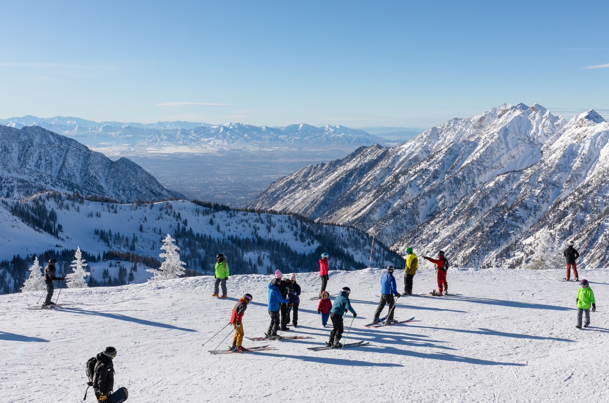 Skiers and snowboarders on top of Hidden Peak,at Snowbird Ski Resort.