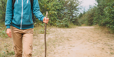 A hiker carrying a stick.