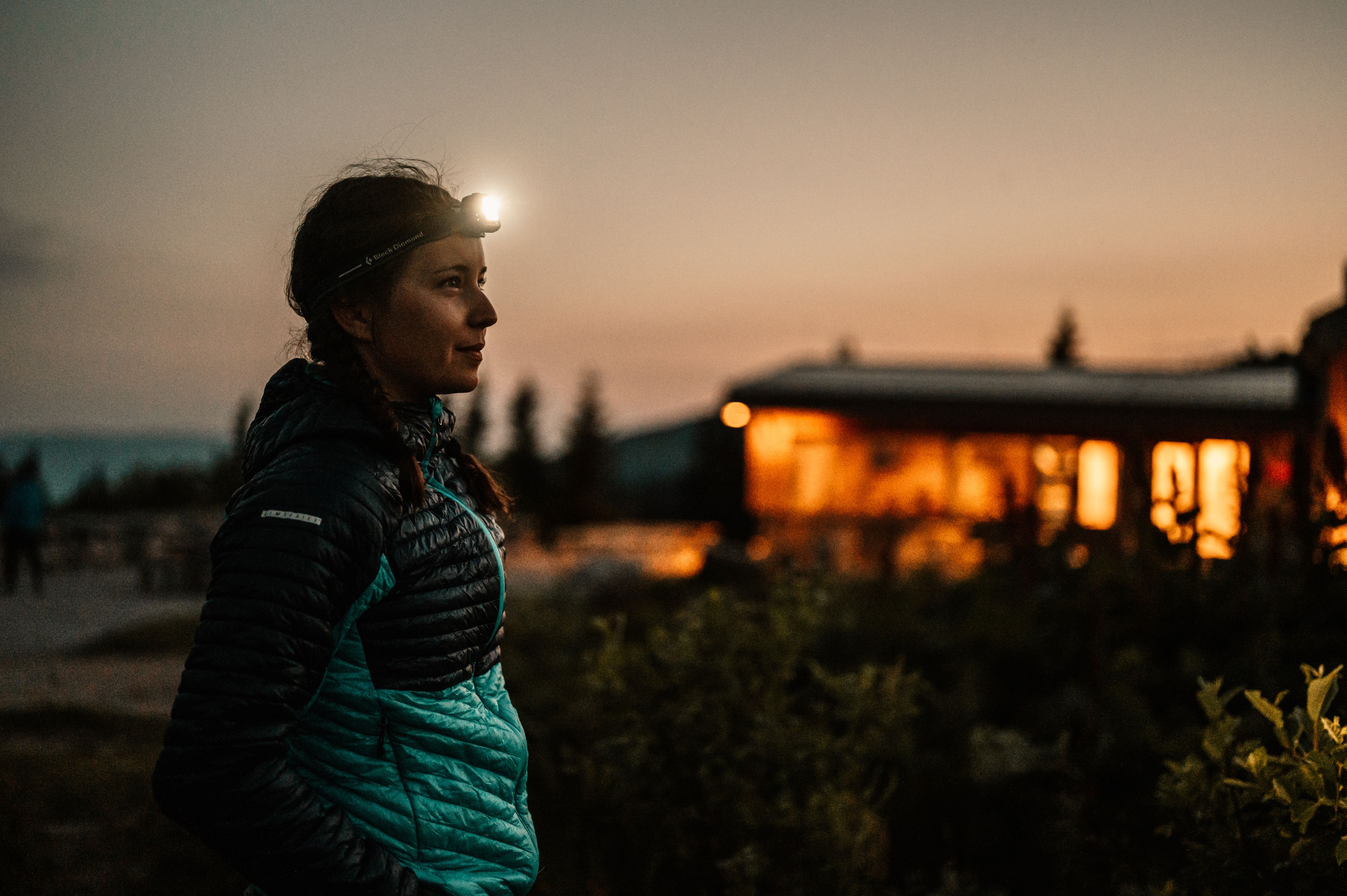 A woman wearing a Black Diamond headlamp.